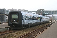 Ic3 trainset MFA 5095 (named Niels Mouritsen) photographed at the railway station in Herning 10. December 2004.  The Ic3 was built by ABB Scandia in Denmark. Each unit consists of 3 coaches. Built in a number of 92 trainsets. The trainsets were put in service in 1989 - 1998. 4 diesel engines of 294 kW per trainset. Max speed 180 km/h - 112 mph. Length 58 800 mm. Weight 97 metric tonnes. 16 seats 1st class, 128 seats 2nd class. Up to 5 trainsets can be put together. The MFA 5095 was put in service in 1991.